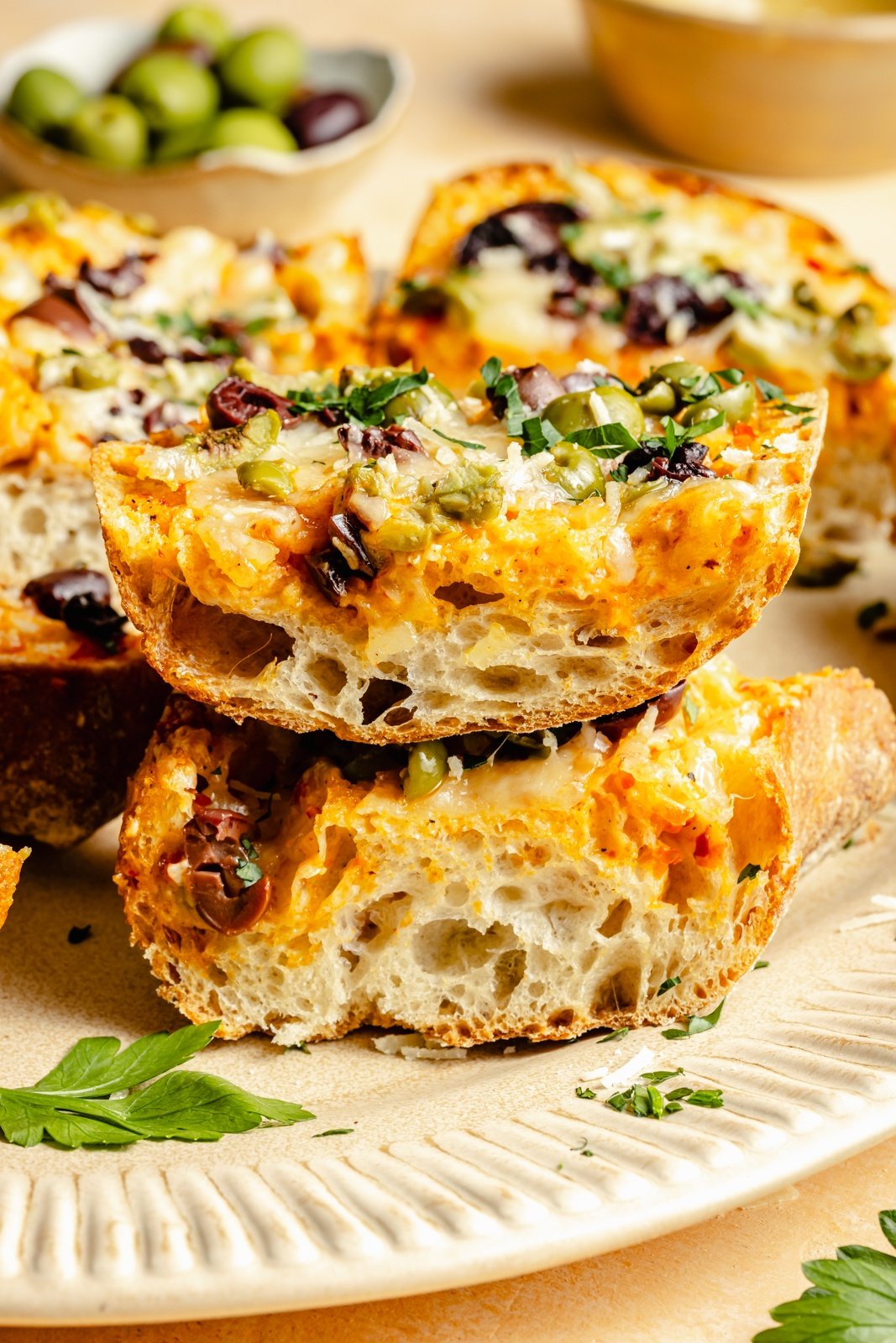 slices of olive cheese bread on a plate