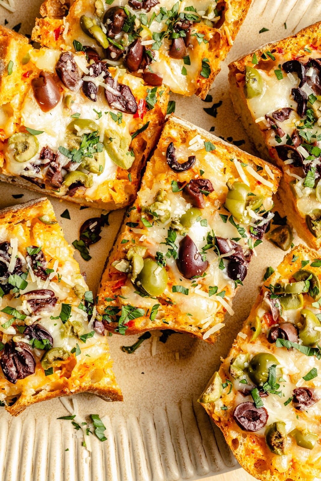 slices of olive cheese bread on a plate
