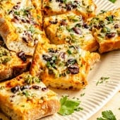 slices of olive cheese bread on a plate
