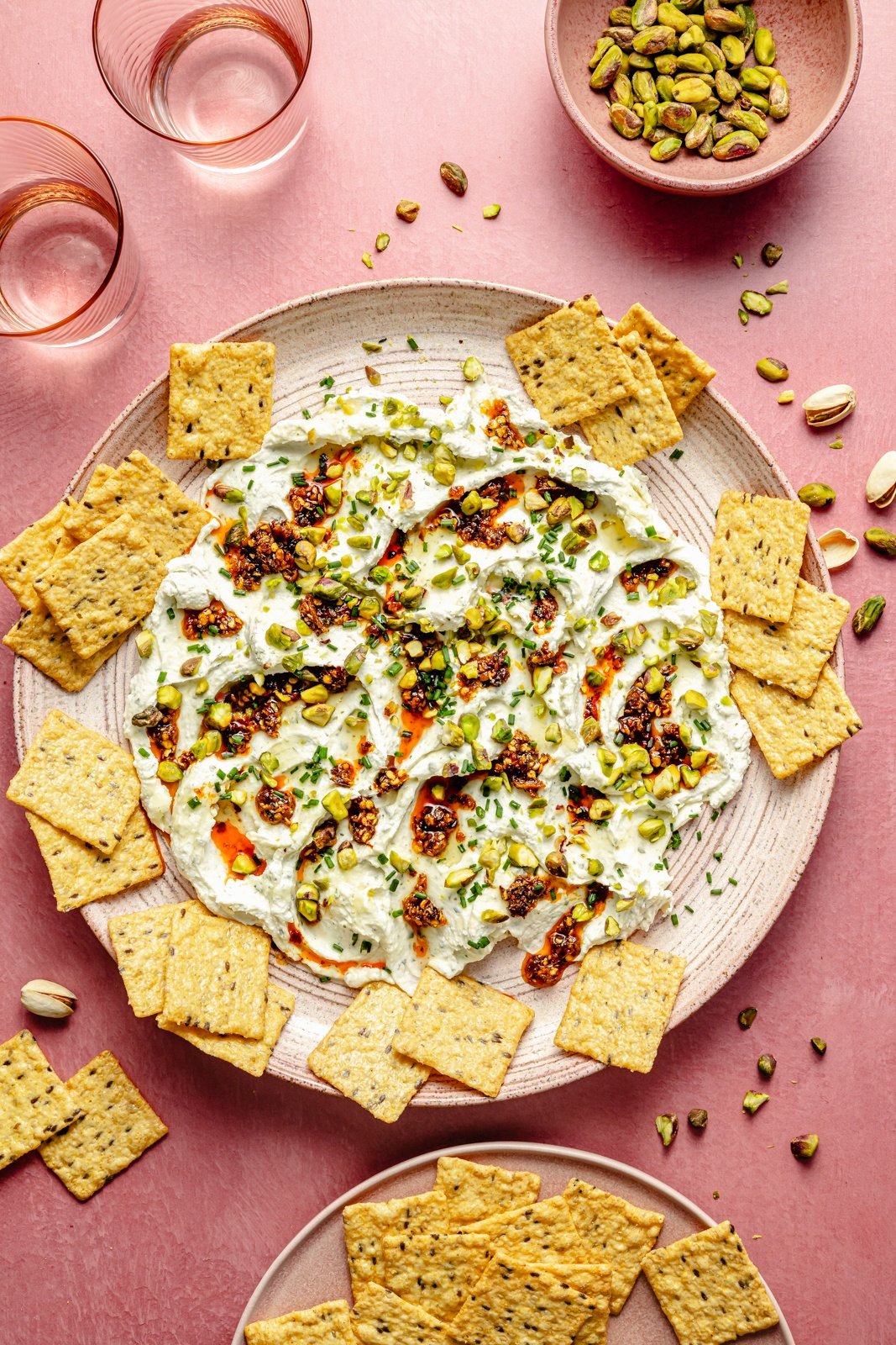 garlic herb cheese dip with crackers around it