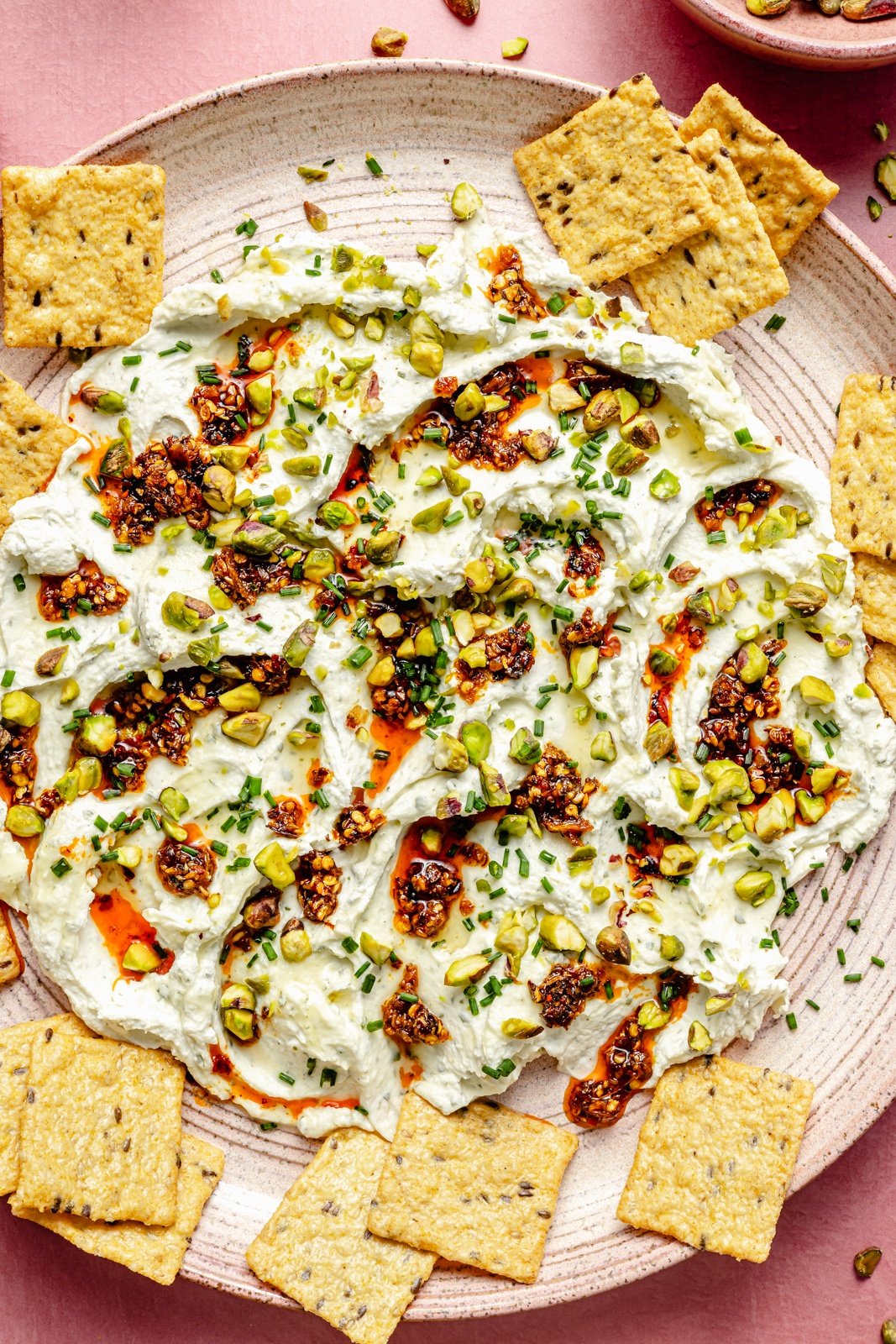 garlic herb cheese dip on a platter with crackers
