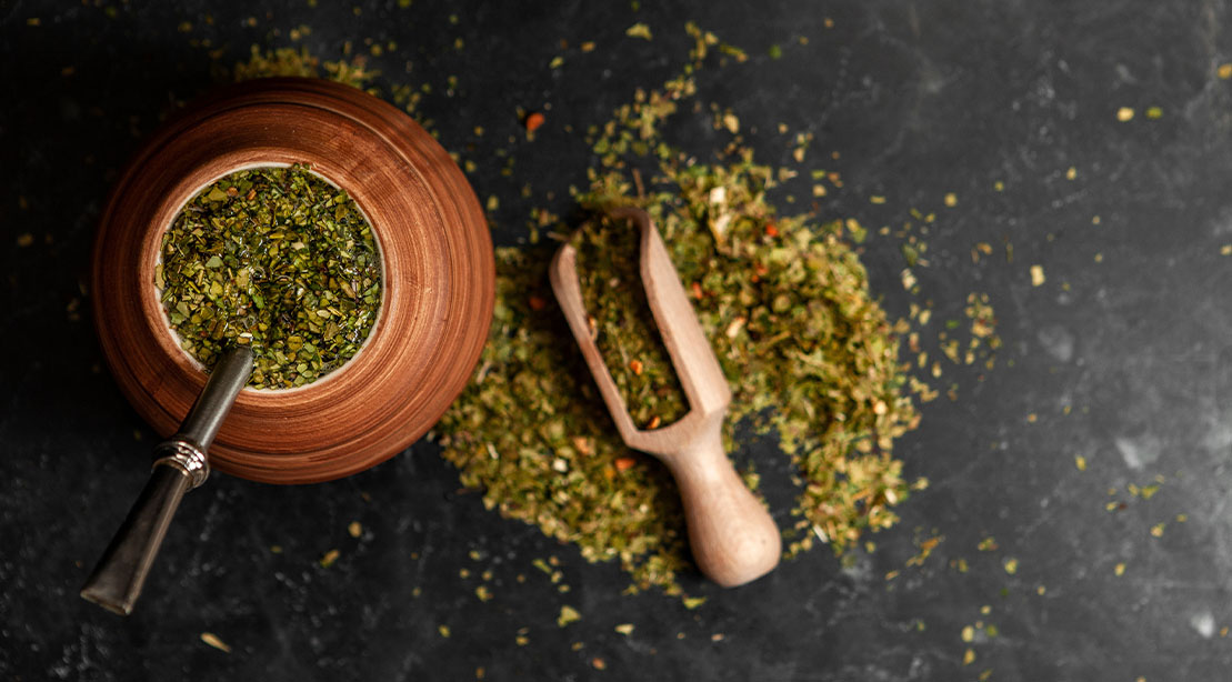 A cup and bowl full of Yerba Mate mixture