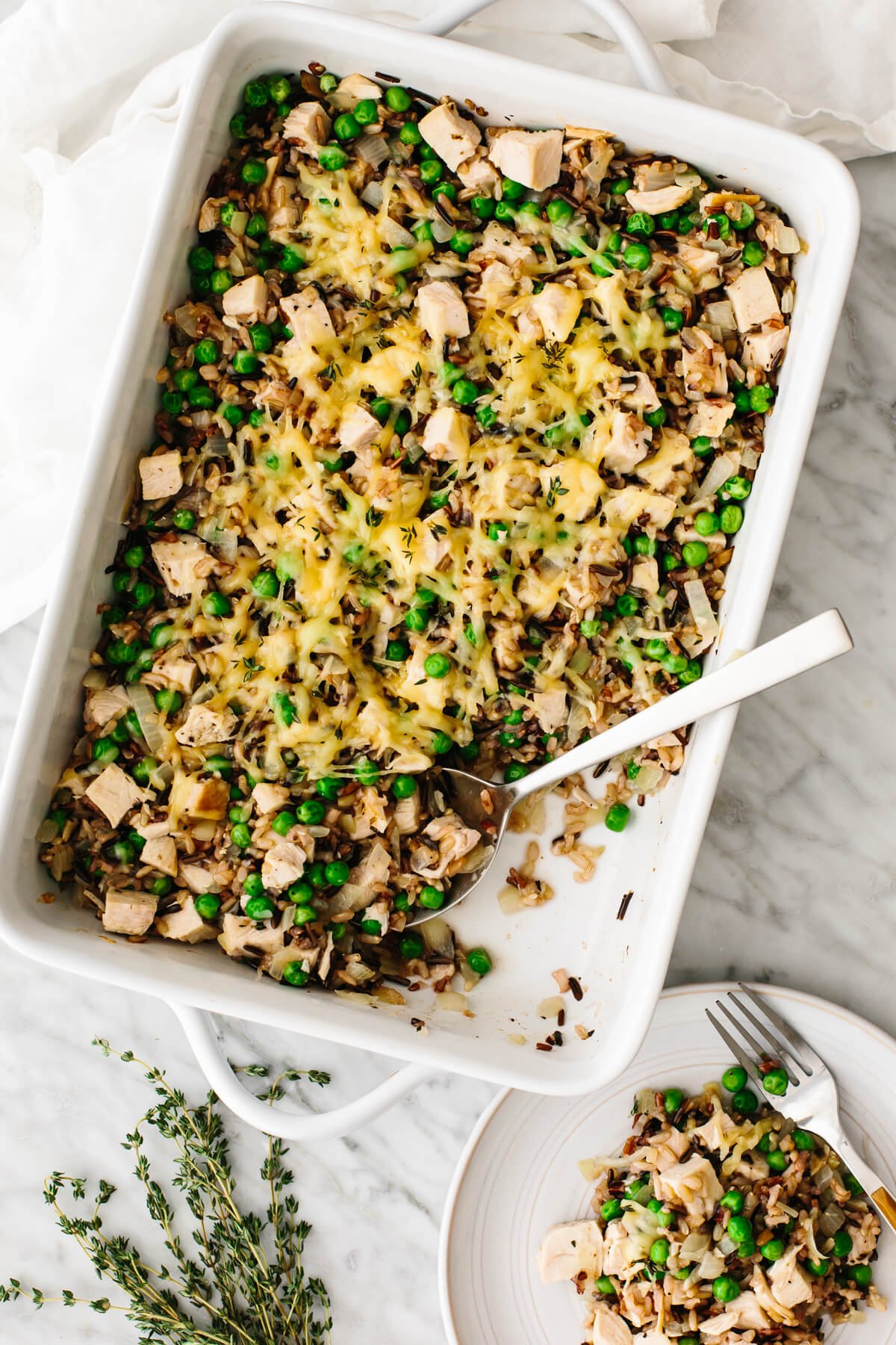 A turkey casserole dish on a table with a spoon in it.