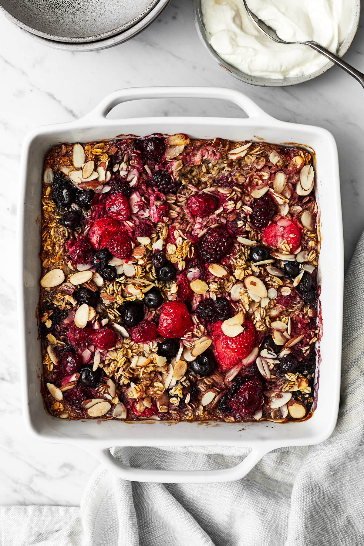 Baked oatmeal with berries in a baking dish.