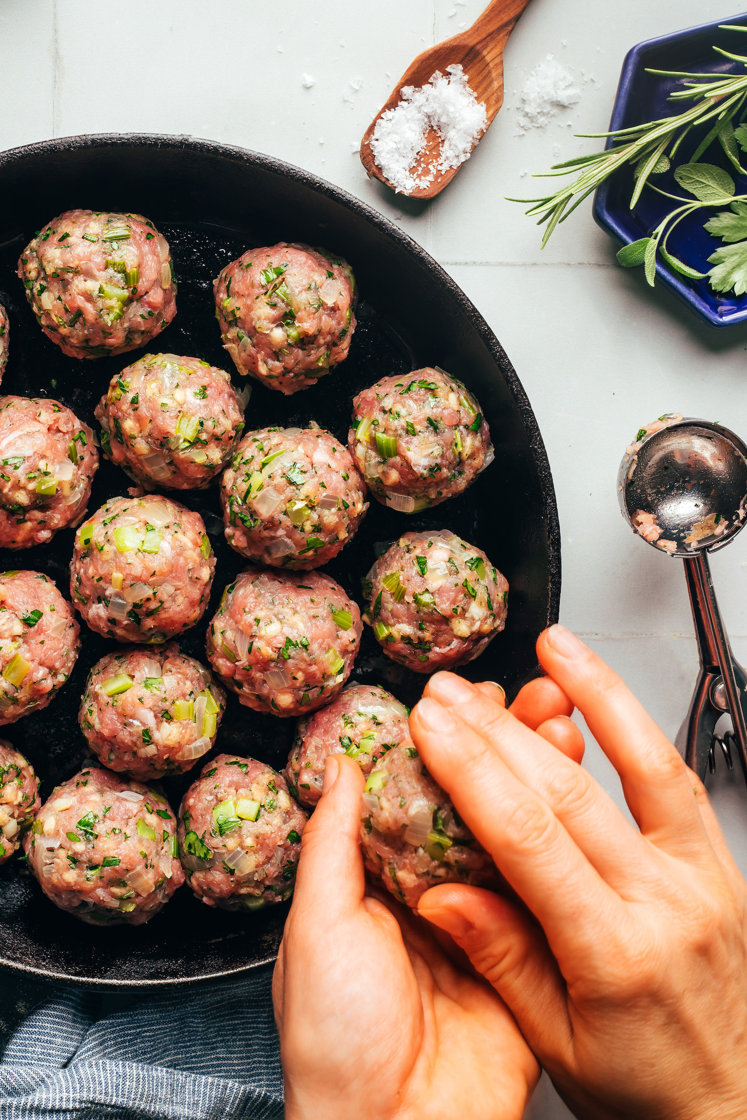 Using our hands to form turkey meatballs into one-and-one-half-inch balls
