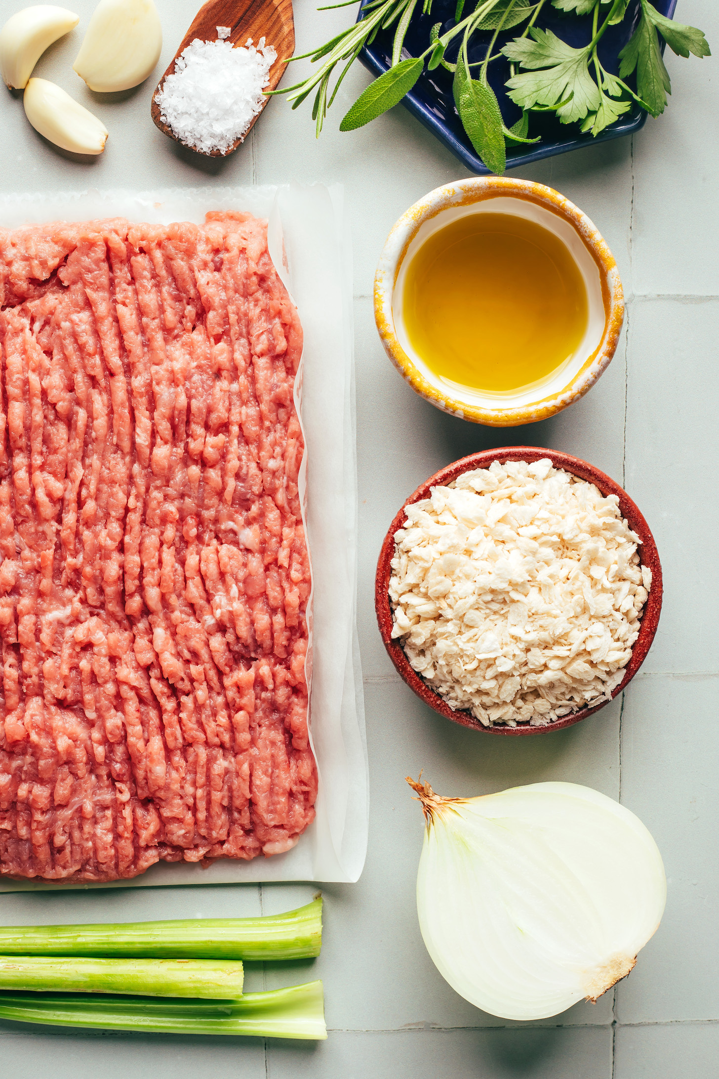 Rosemary, sage, parsley, olive oil, breadcrumbs, onion, celery, ground turkey, salt, and garlic cloves