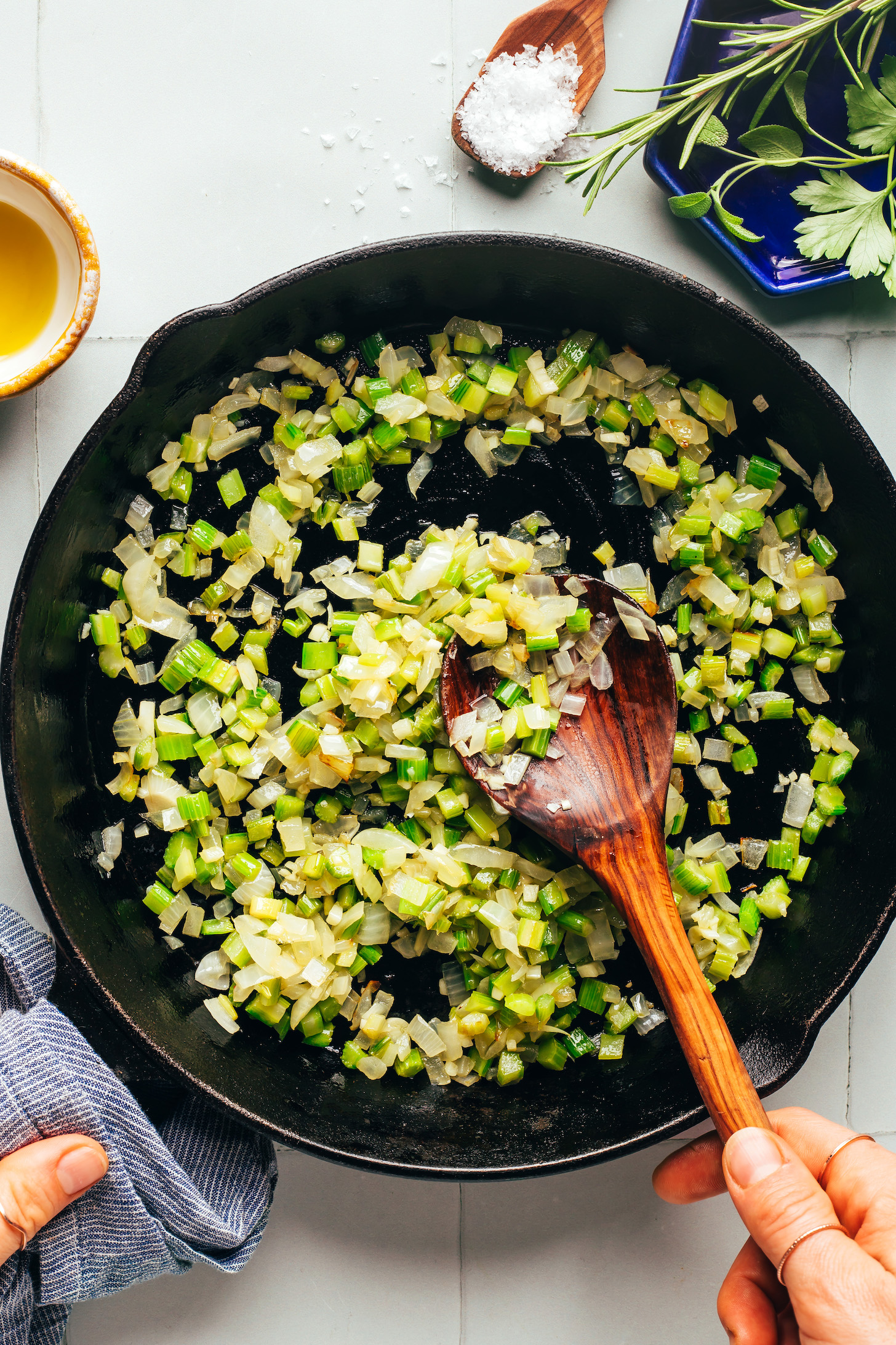 Sautéing onion and celery in a cast iron skillet