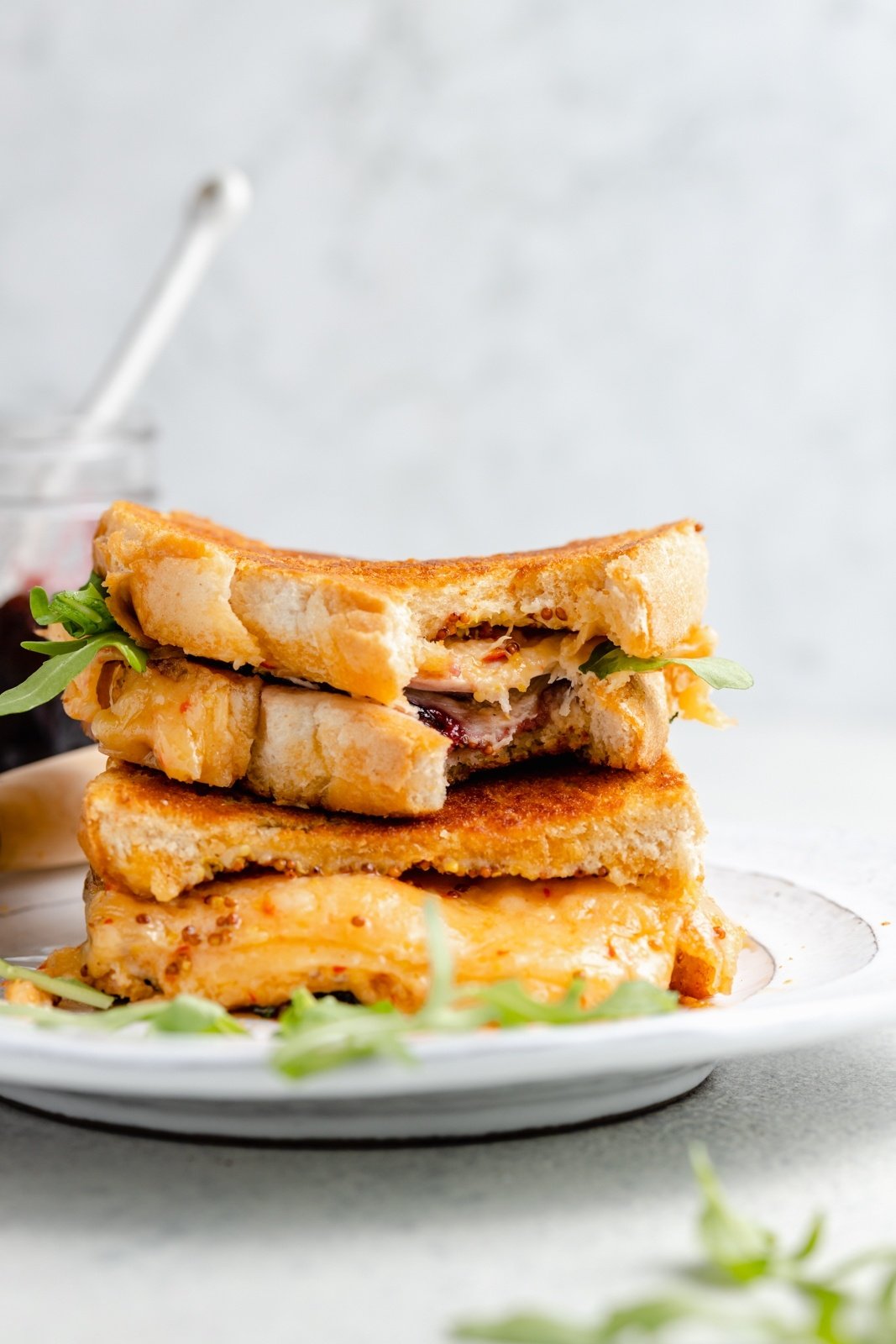 Delicious, easy leftover turkey recipes that you're going to love! From slow cooker recipes to soups and even enchiladas, these recipes using leftover turkey are the perfect way to jazz up your Thanksgiving leftovers. turkey grilled cheese sandwiches with cherry jam in a stack