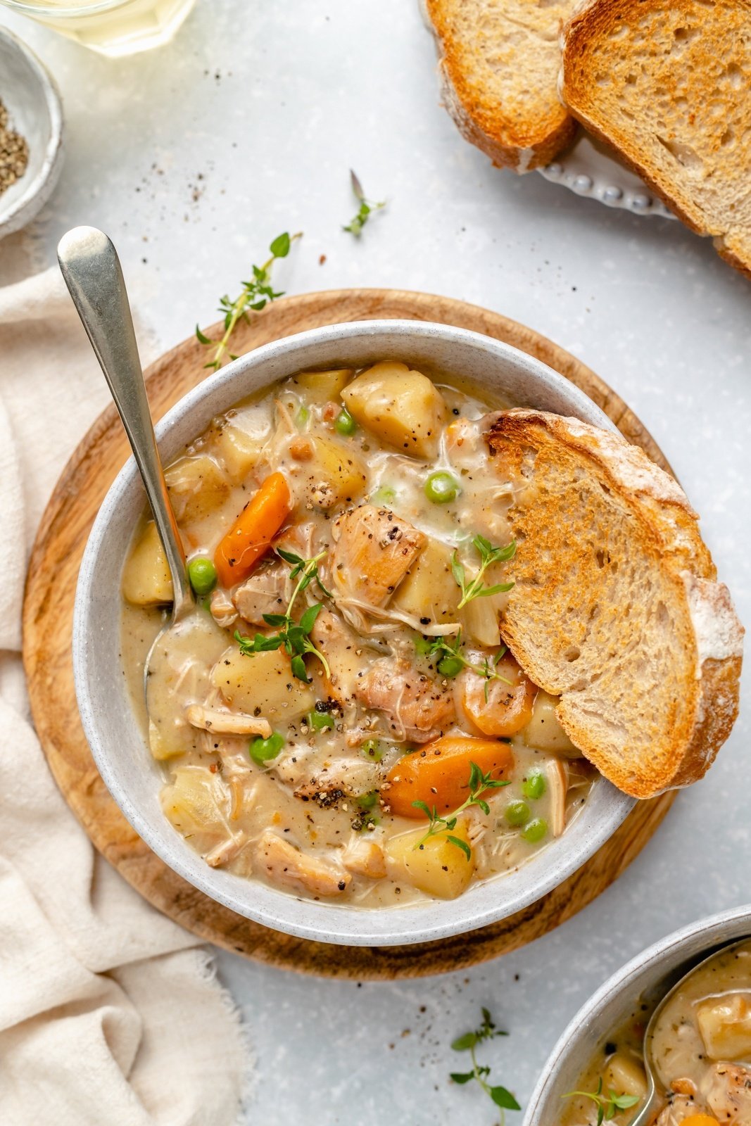 Delicious, easy leftover turkey recipes that you're going to love! From slow cooker recipes to soups and even enchiladas, these recipes using leftover turkey are the perfect way to jazz up your Thanksgiving leftovers. white wine turkey stew in a bowl with a piece of bread