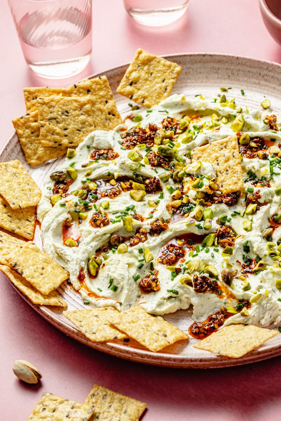 chili crisp honey cheese dip in a platter with crackers