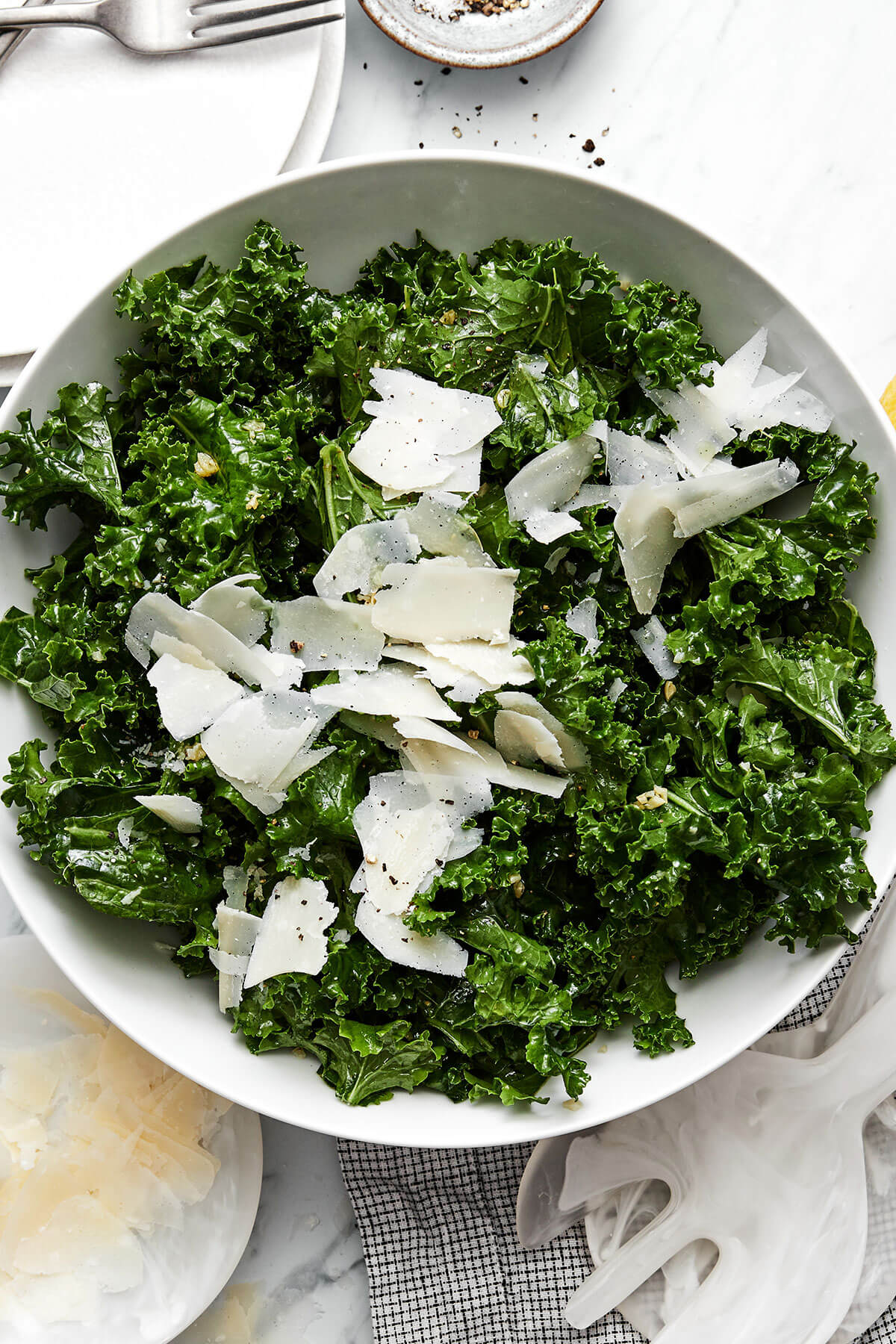 A bowl of kale salad with parmesan.