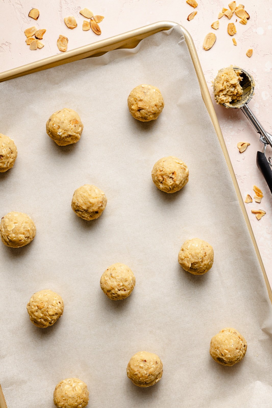 unbaked almond oatmeal cookies on a baking sheet