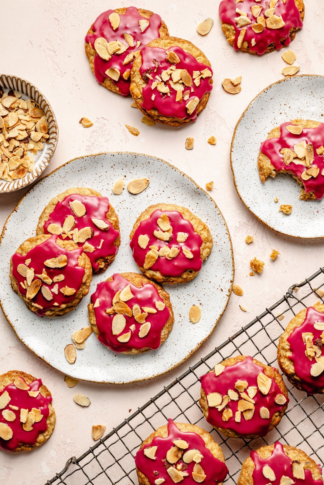 cherry almond cookies on plates and on a wire rack