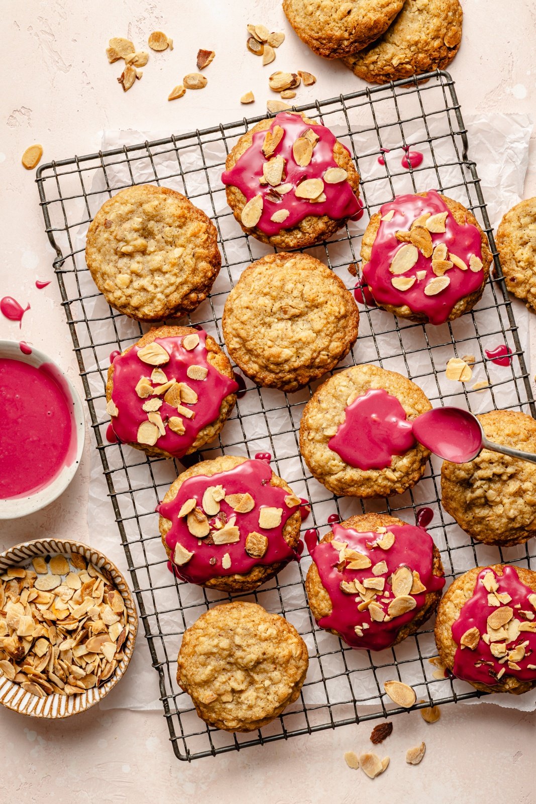 almond oatmeal cookies with cherry icing on a wire rack