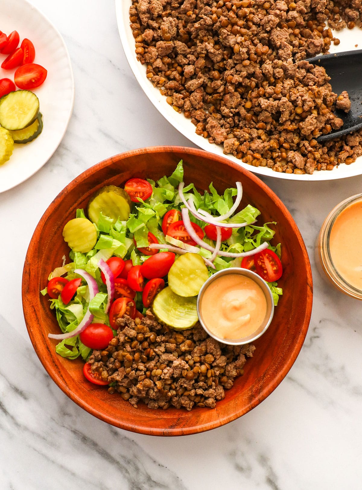 burger bowls assembled with special sauce on the side. 