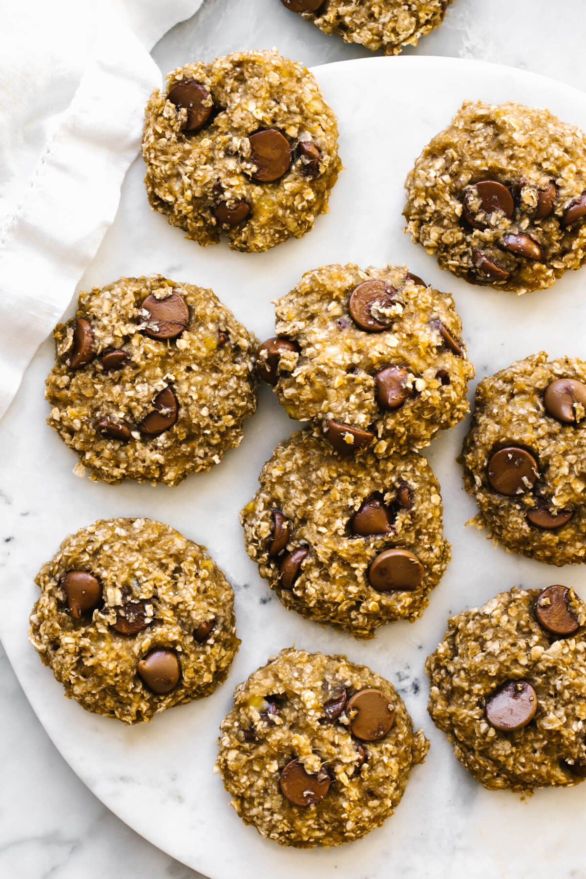 Banana oatmeal cookies laid out on a marble plate.