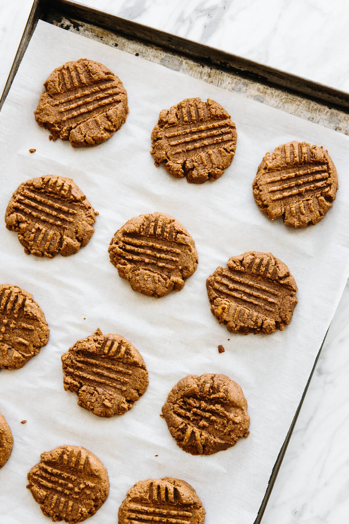 Almond butter cookies on a baking tray.