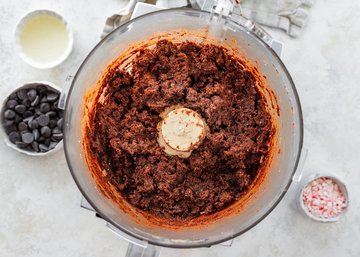 Food processor filled with chocolate date mixture for peppermint protein balls.