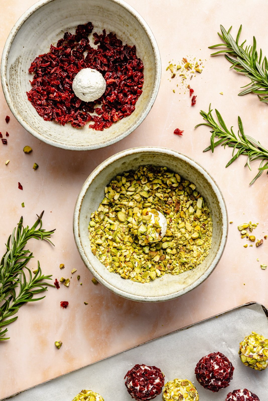 rolling cheese truffles in pistachios and dried cranberries