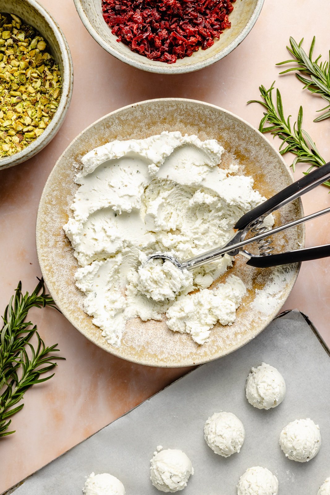 scooping cheese into balls to make cheese truffles
