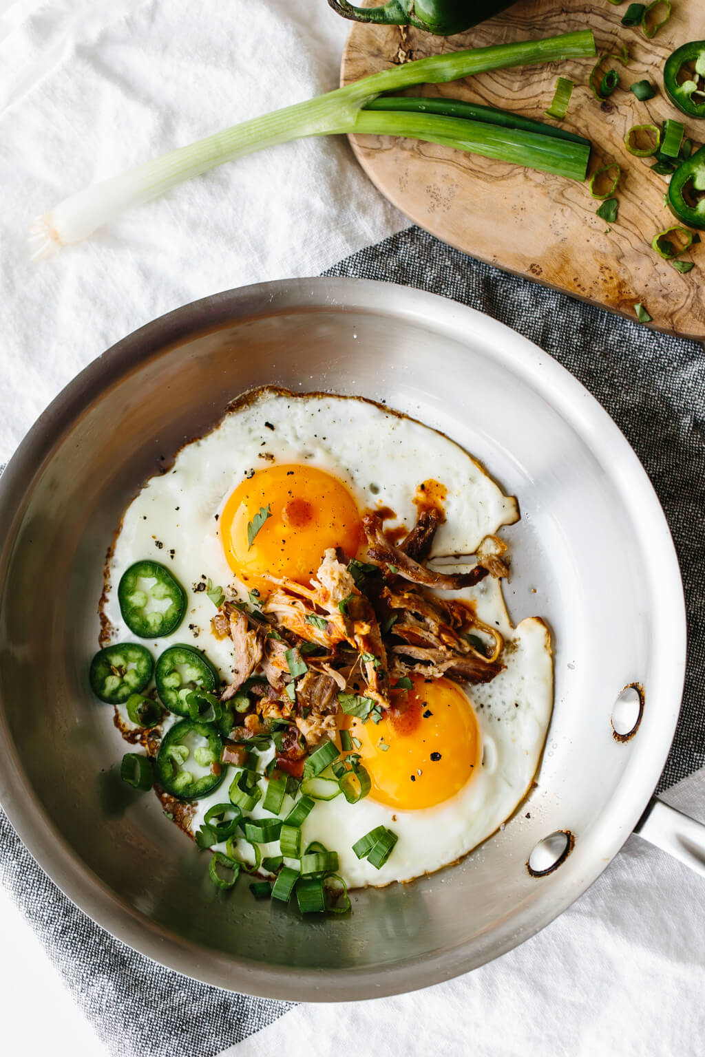 Spicy pulled pork fried eggs are a combination of hot sauce and jalapenos alongside runny eggs and flavorful pulled pork. It's a low-carb, keto, paleo, Whole30 breakfast recipe.