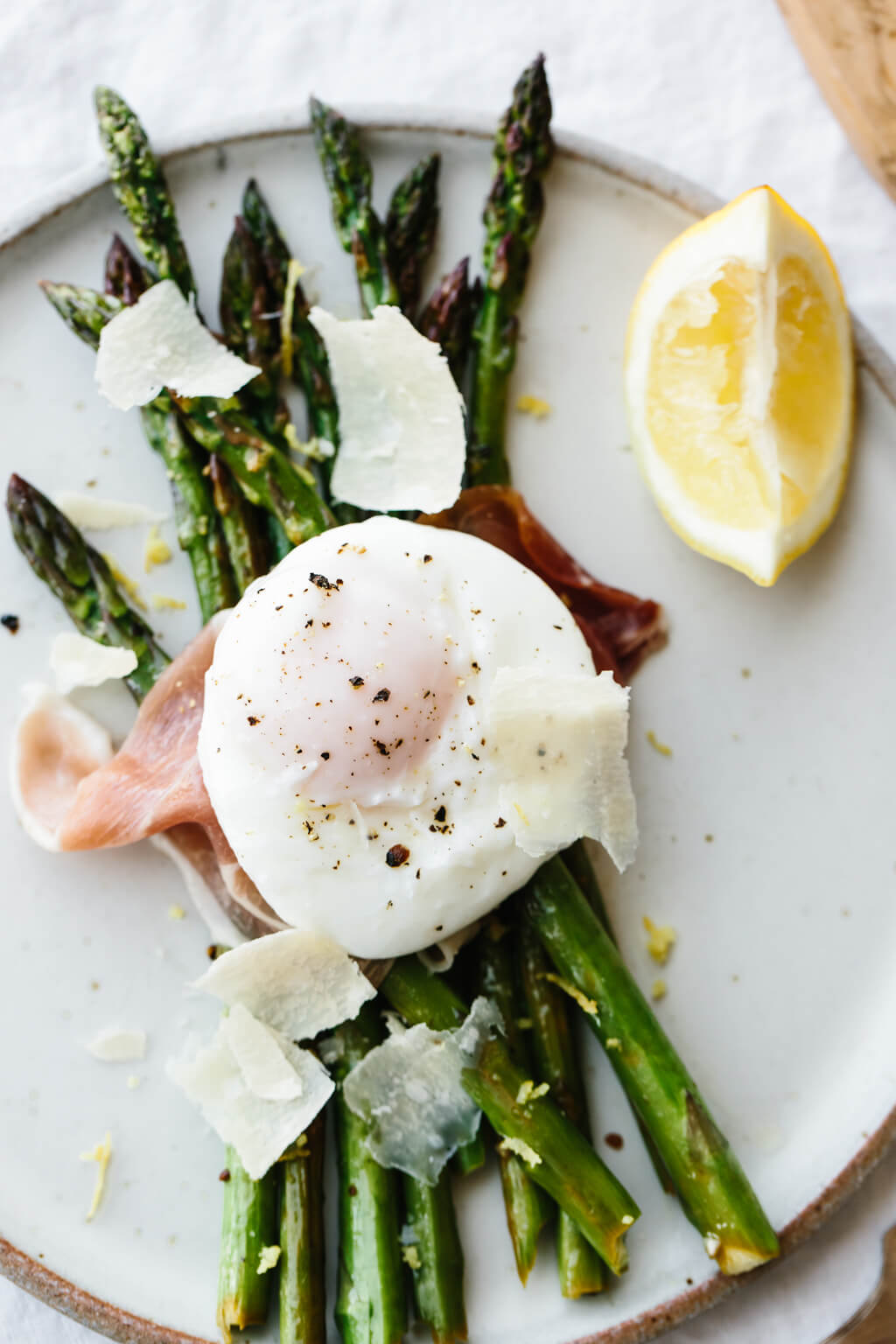 Breakfast doesn't get much better than garlic sautéed asparagus topped with prosciutto, a perfectly poached egg and a few shavings of parmesan.