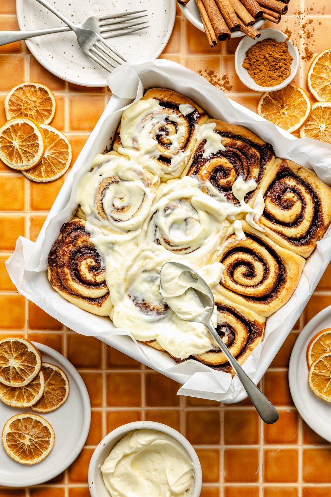 frosting orange cinnamon rolls with orange frosting