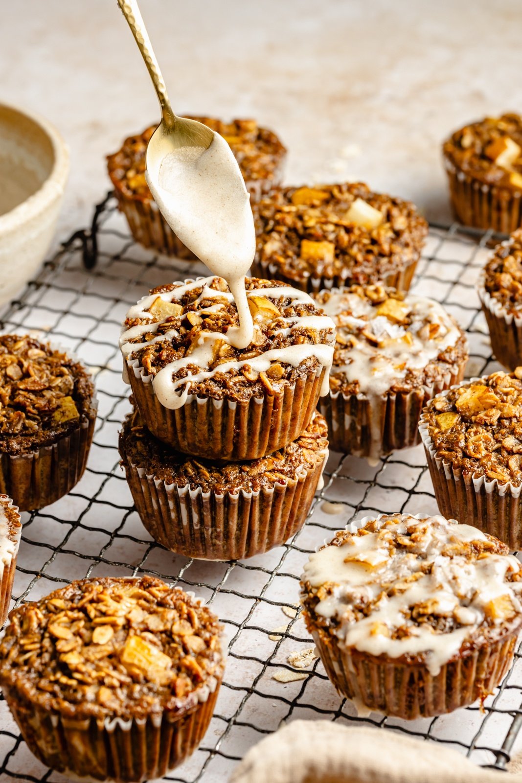 drizzling a glaze onto gingerbread baked oatmeal cups