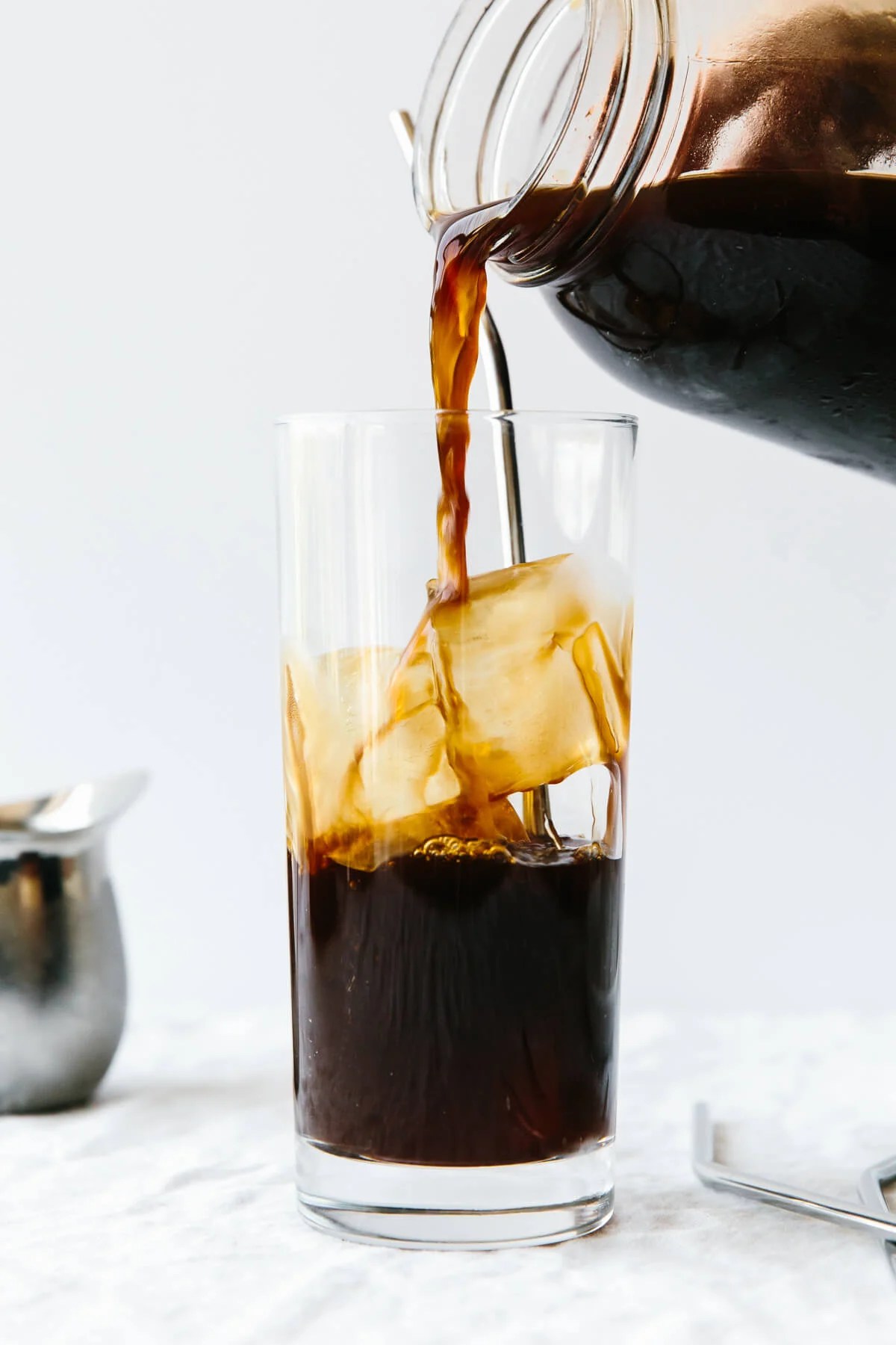 Pouring cold brew into a cup of ice