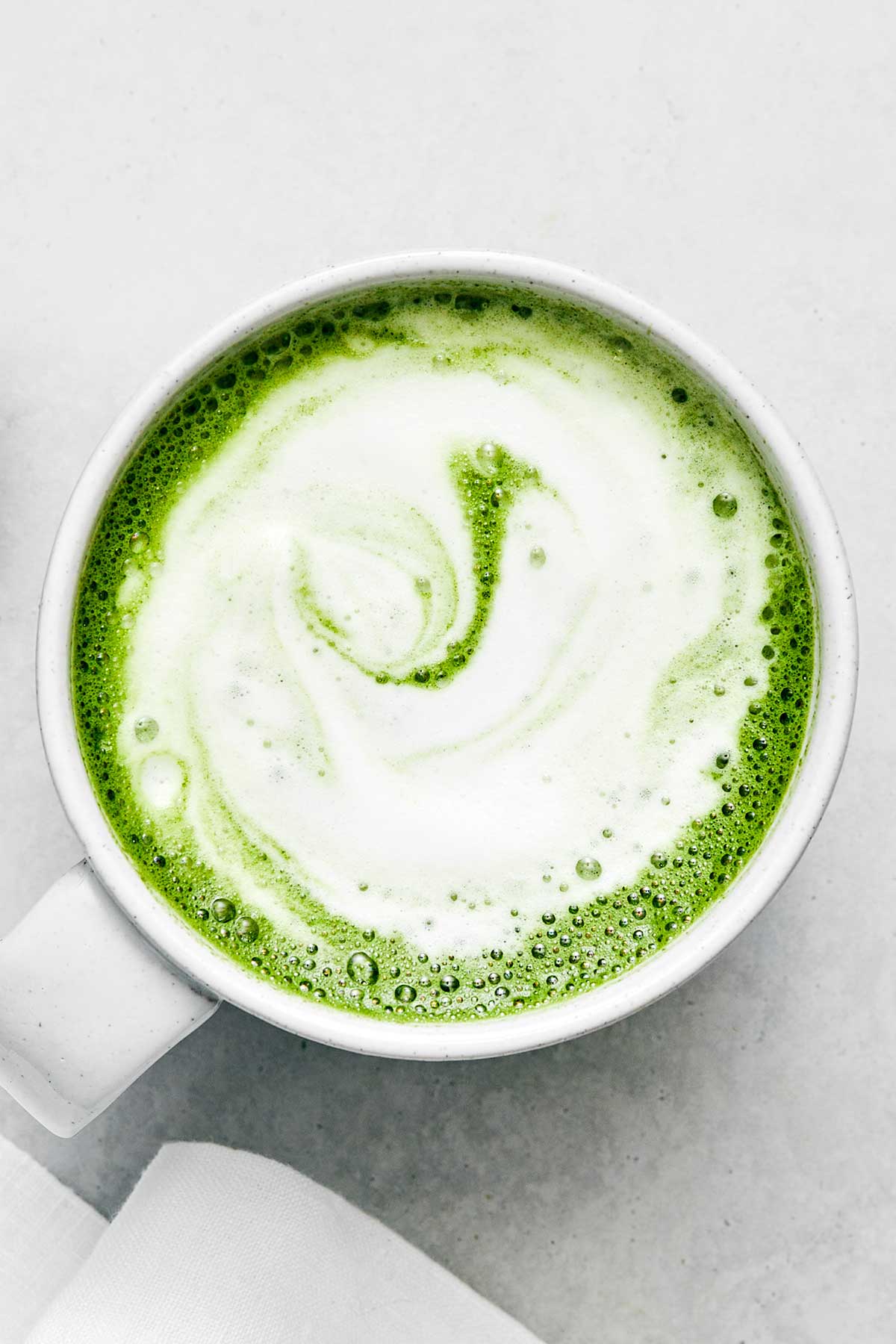 A white mug of matcha latte.