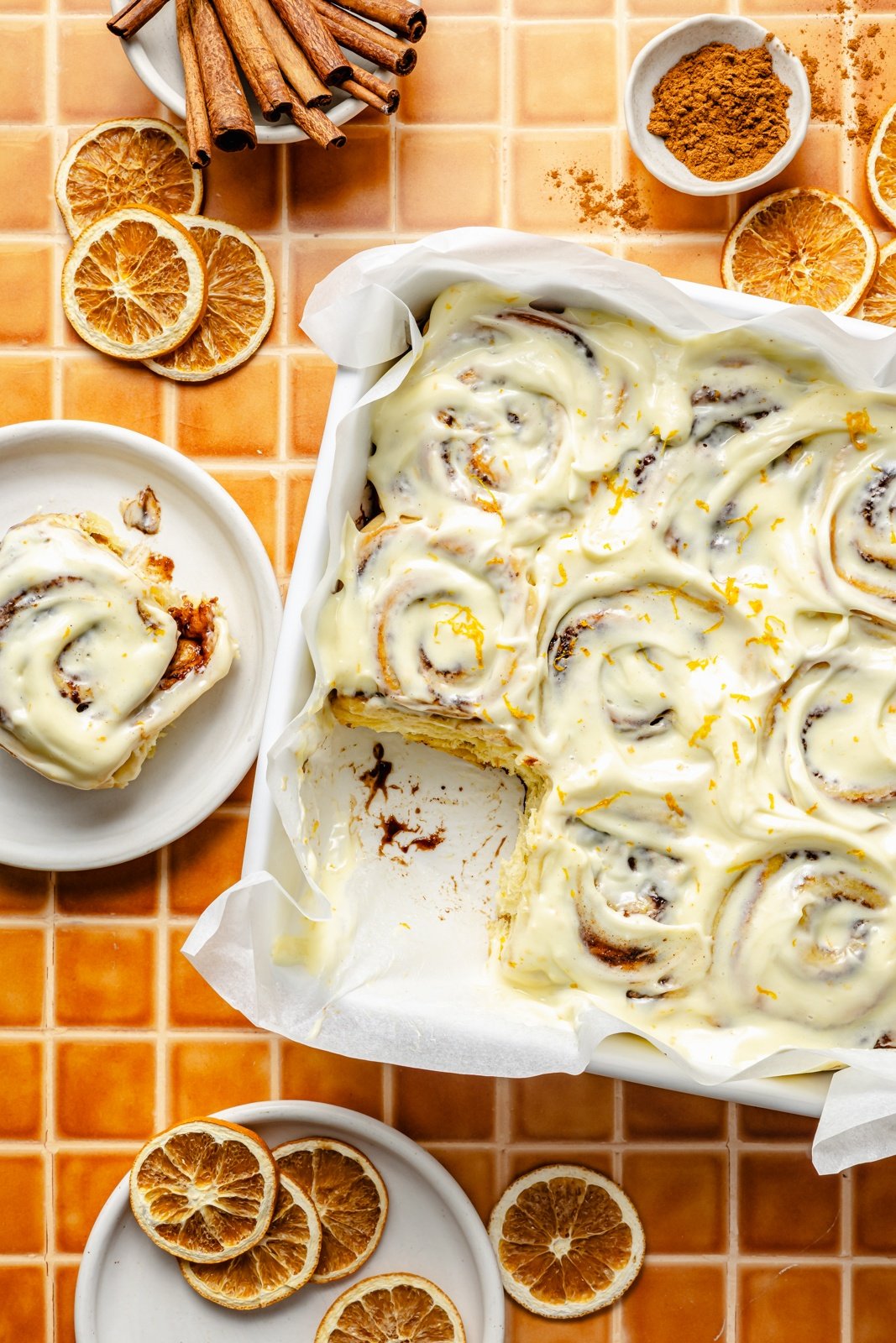 orange cinnamon rolls in a pan and on a plate
