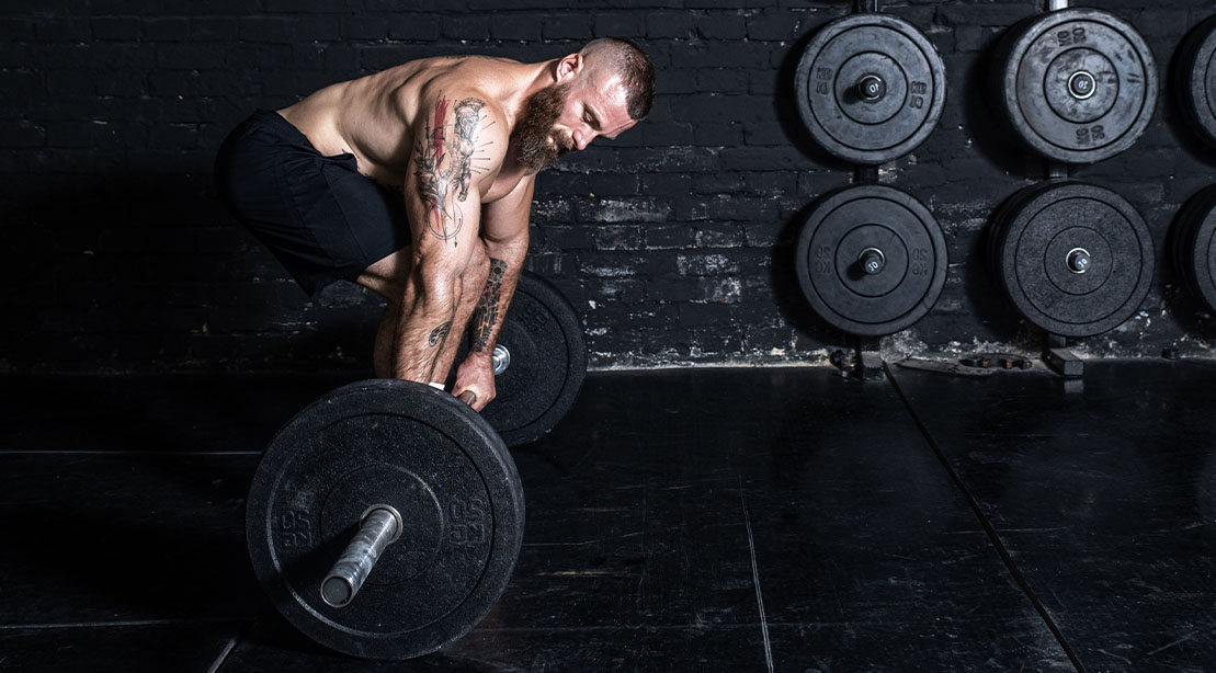 Fit young athletic muscular man prepping his workout with a deadlift exercise