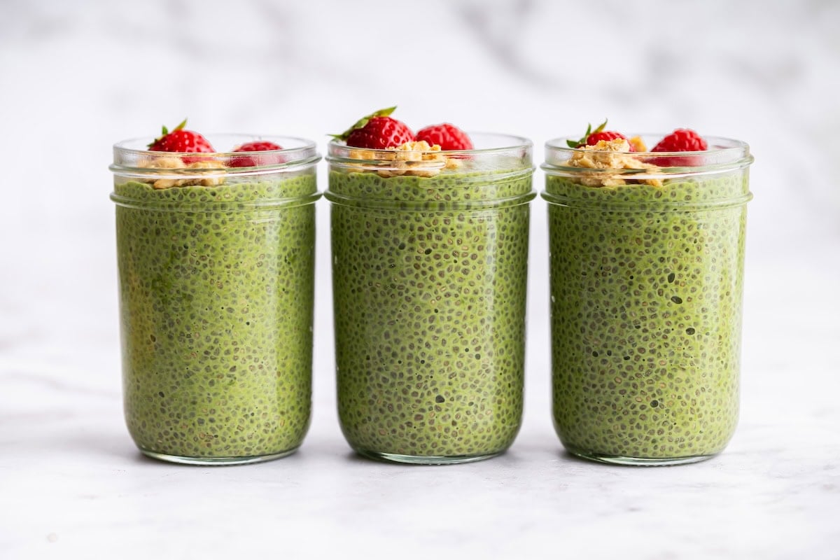 Three jars of green matcha chia pudding lined up for easy breakfast meal prep.