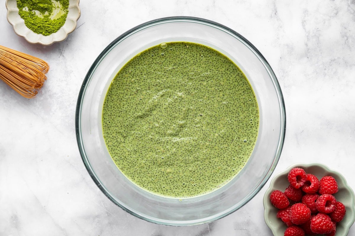 Creamy matcha chia pudding in a glass bowl after soaking for a few hours.