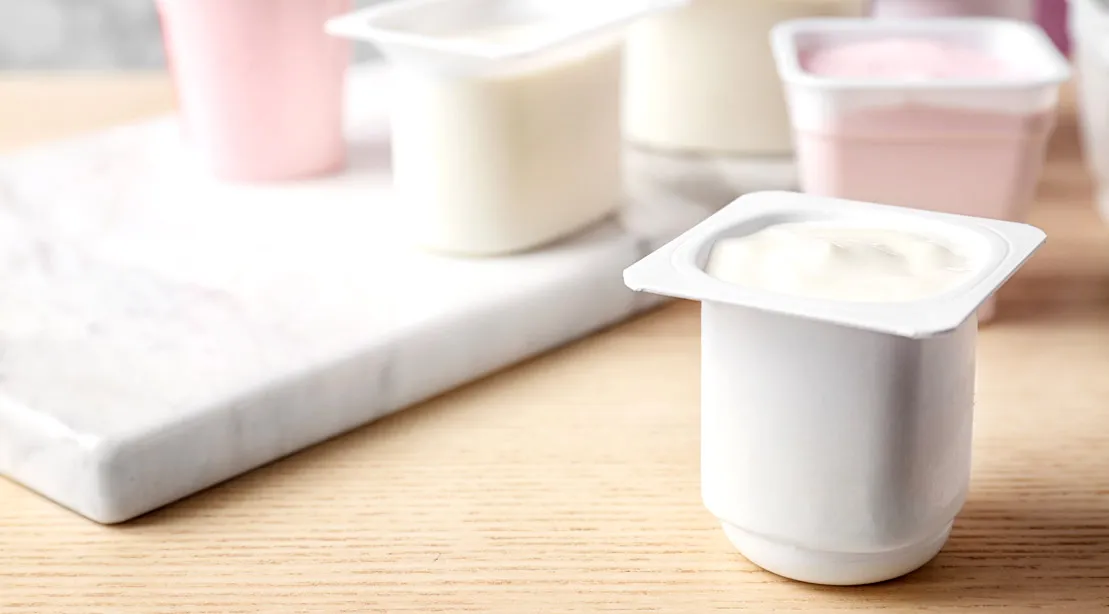Packaged strawberry and plain yogurt containing probiotics that's good for your gut health