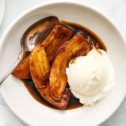 A white bowl of Bananas Foster.