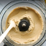 hummus in a food processor labeled for pinterest.