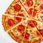 best cauliflower pizza sliced into pieces.