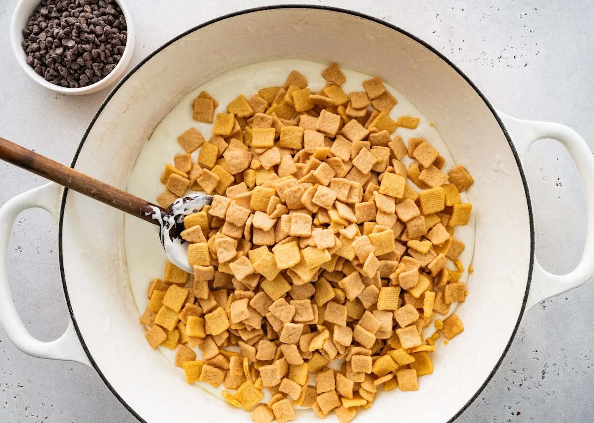 Cereal added to a pot of melted marshmallows.