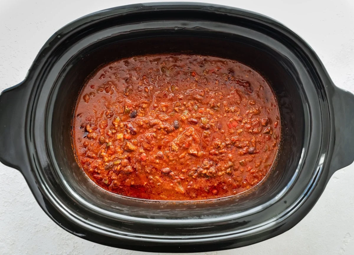 Ground beef and bean chili being cooked in a slow cooker.