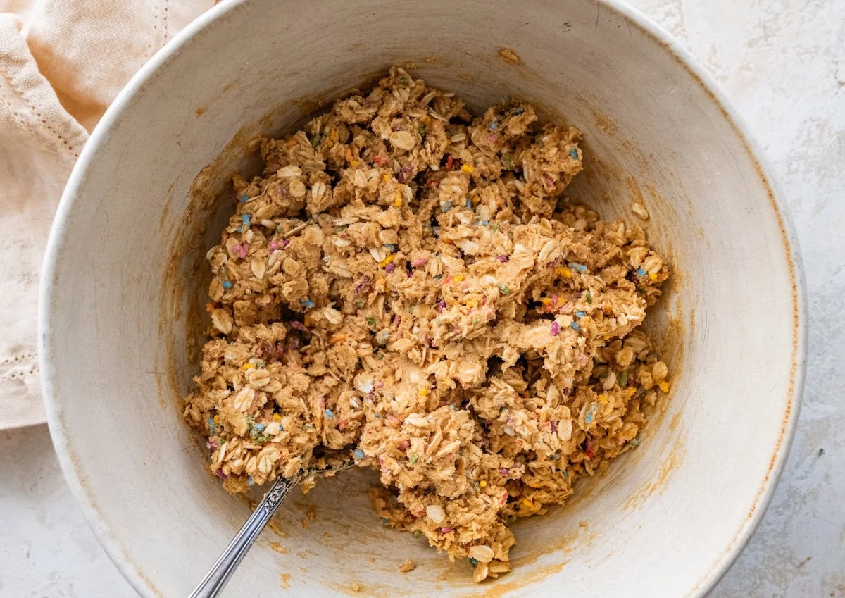 A large mixing bowl of birthday cake protein ball dough.