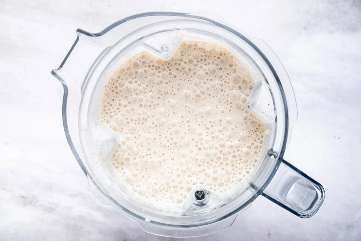 A blended cake batter protein shake in the base of a Vitamix blender.