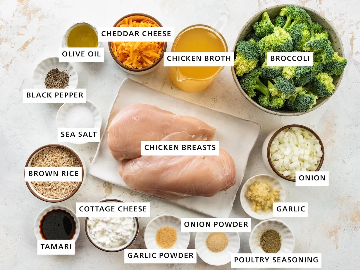 Ingredients used for slow cooker chicken and rice includes: chicken breasts, brown rice, broccoli, chicken broth, cheddar cheese, olive oil, black pepper, sea salt, tamari, cottage cheese, garlic powder, onion powder, poultry seasoning, garlic, and onion.