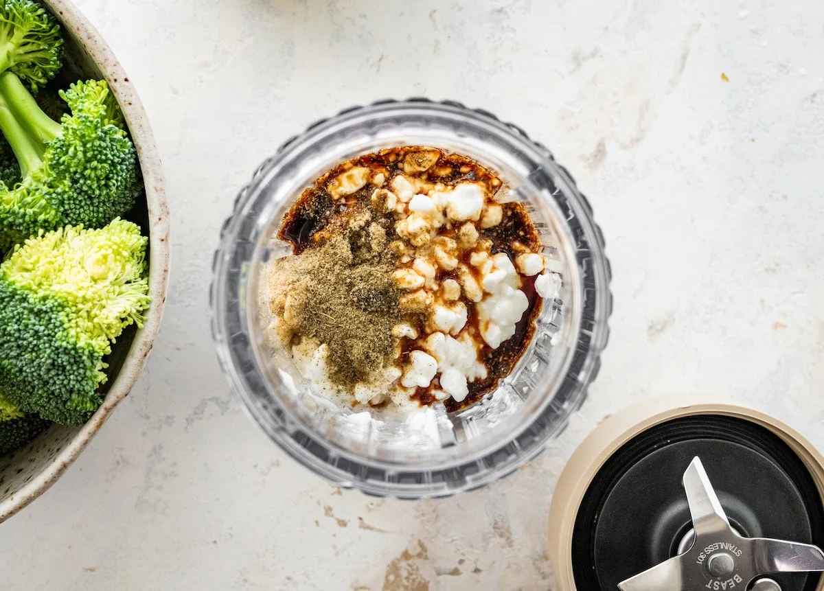 A bullet blender with cottage cheese, tamari, and seasonings.