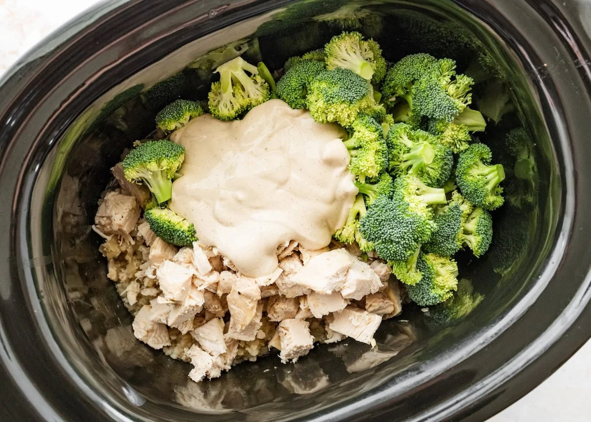A creamy cottage cheese sauce added to a slow cooker along with broccoli florets for a slow cooker chicken and rice recipe.