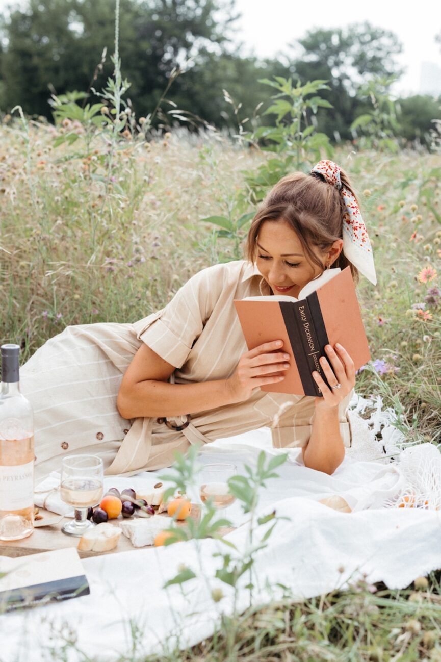 Woman reading one of the best romantic books and having picnic.
