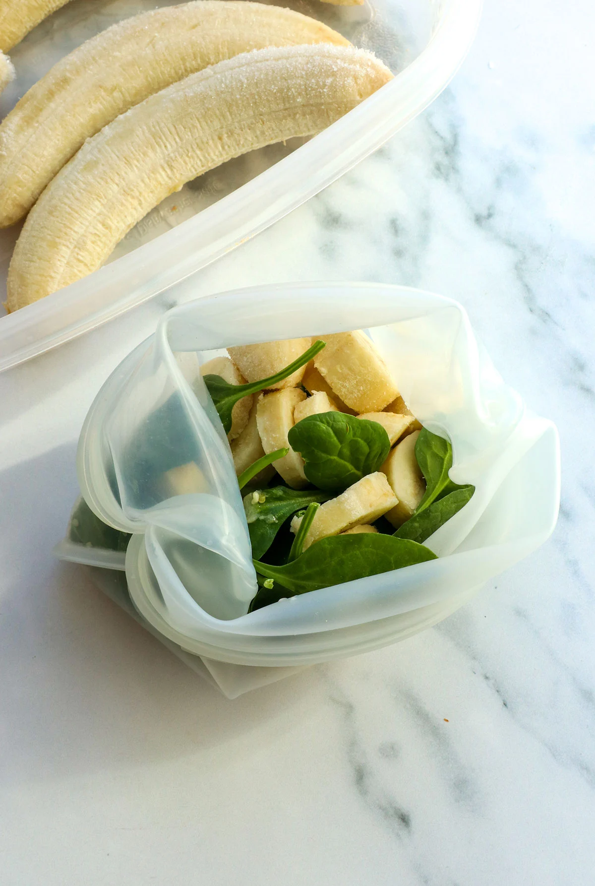 spinach and sliced banana in a reusable silicone bag. 