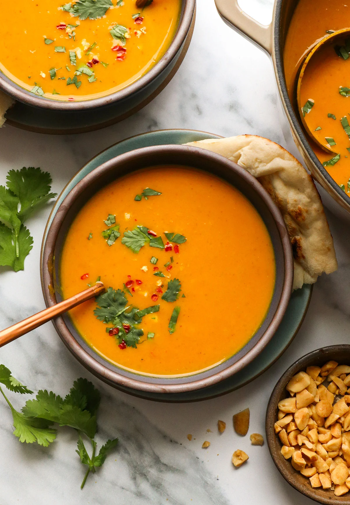 pumpkin curry soup served with cilantro on top.