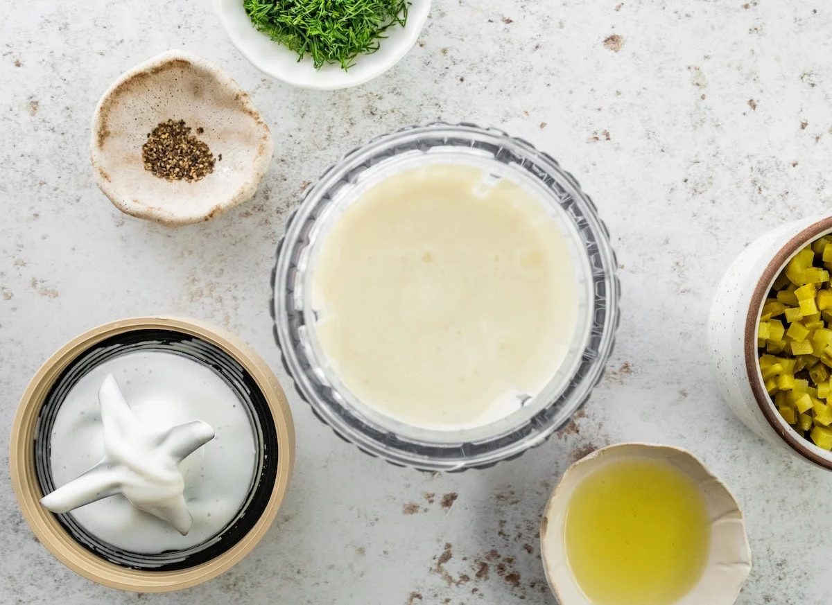 A small blender with a cottage cheese and greek yogurt mixture.