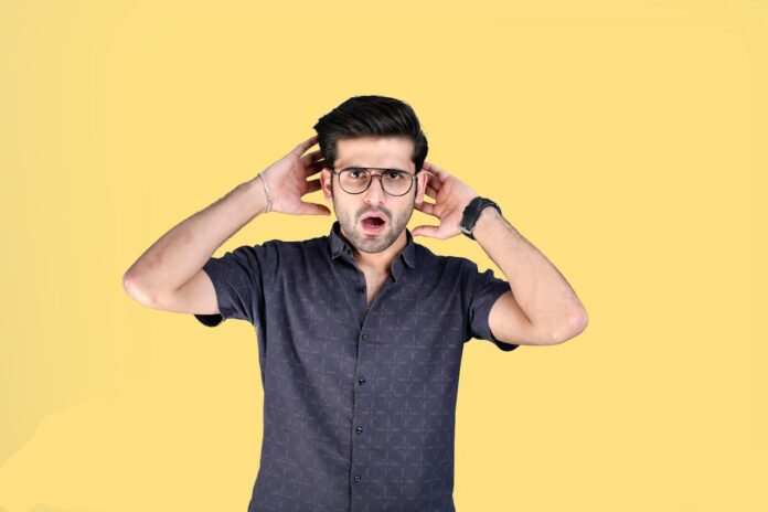 a man with his hands on his head